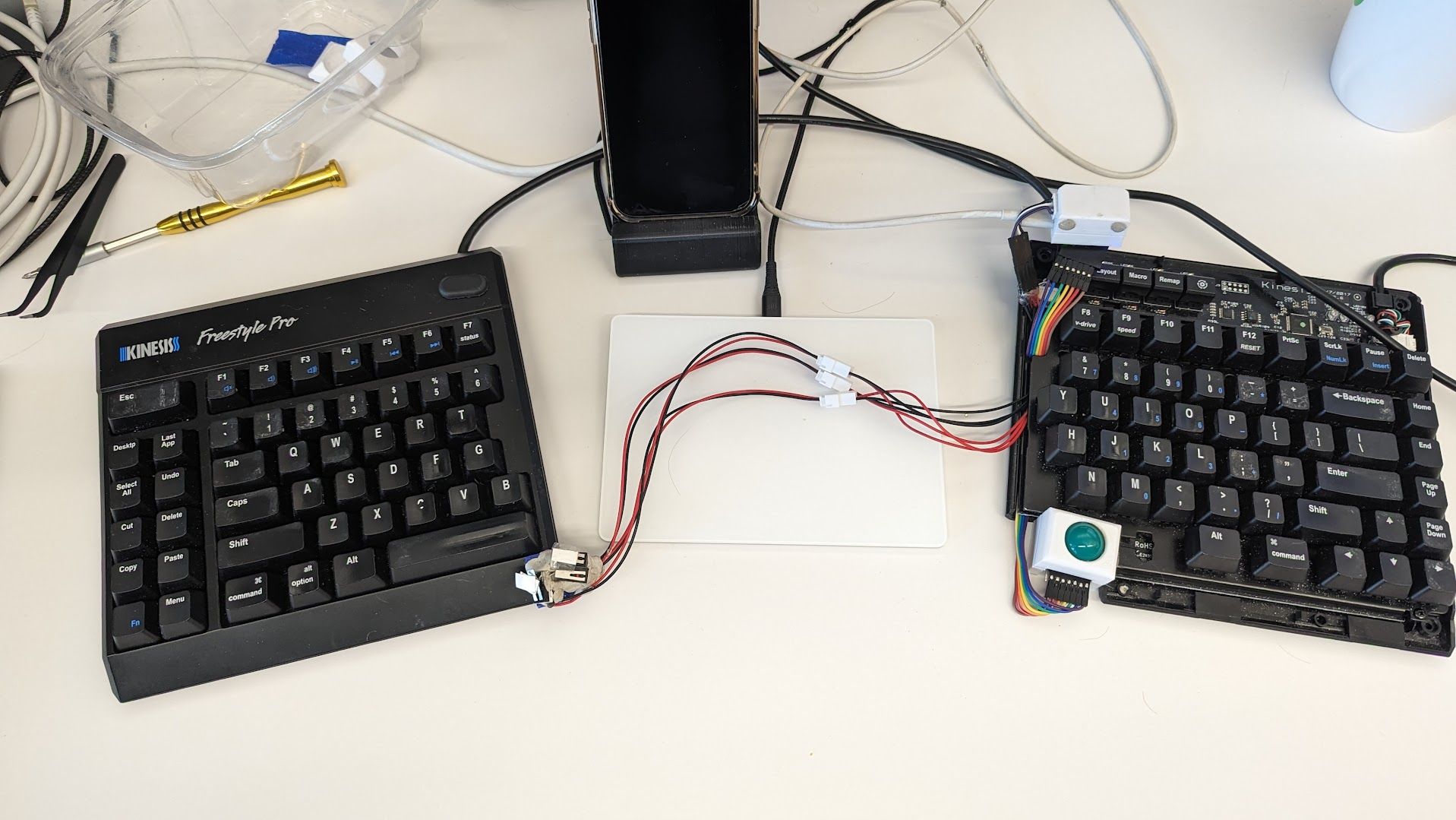 A hacked together prototype of a split keyboard with a trackball replacing the right spacebar.