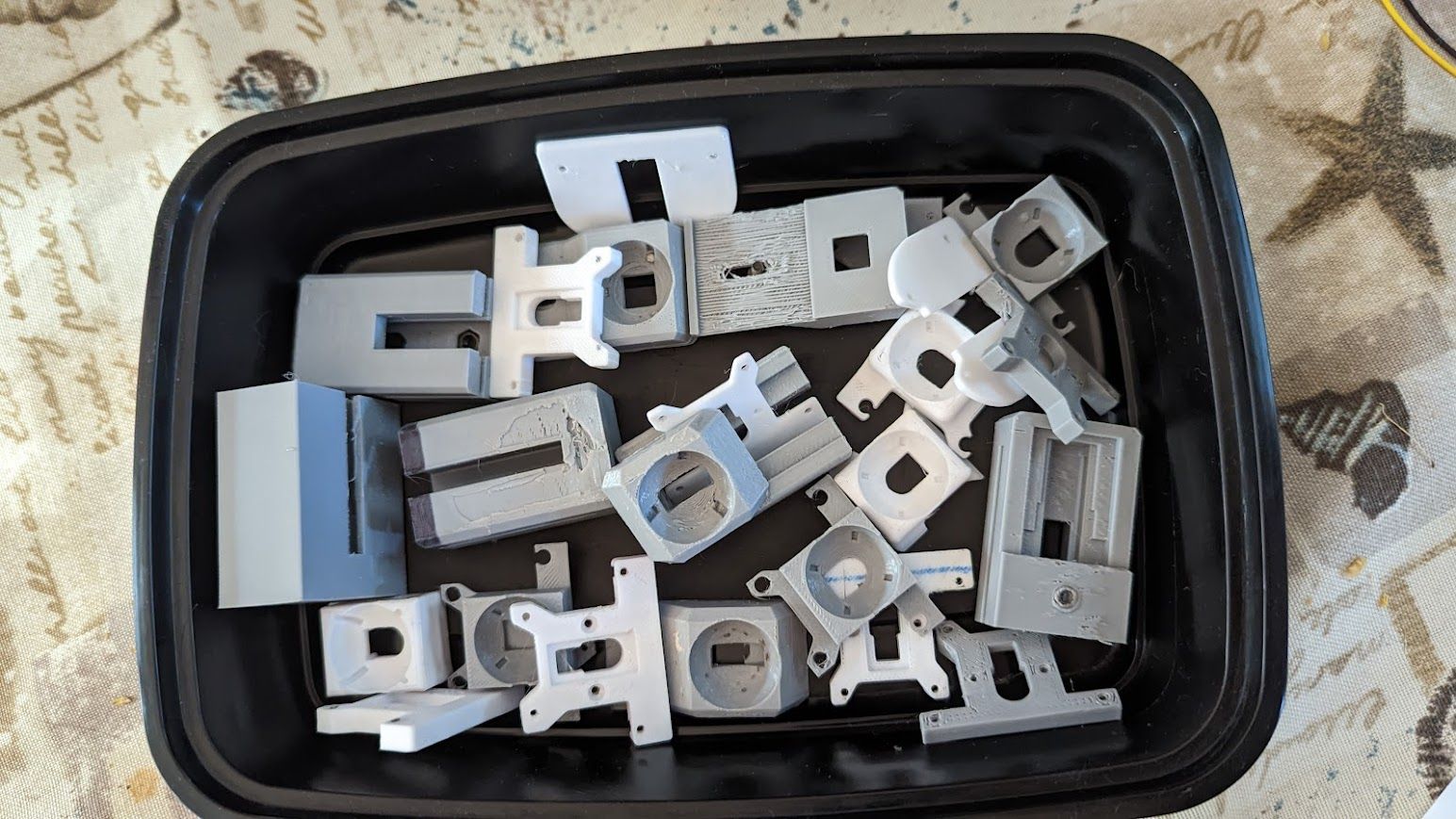 A takeout container full of plastic prototype housings.