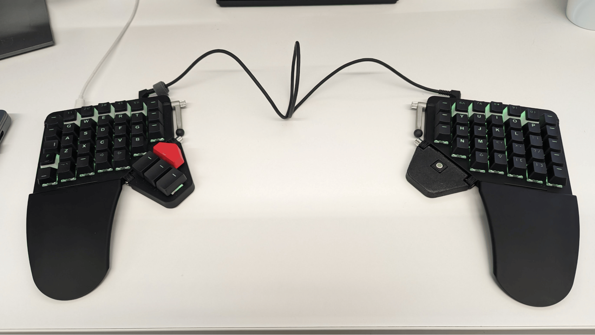 A moonlander keyboard with the right thumb cluster replaced by a tiny trackball.