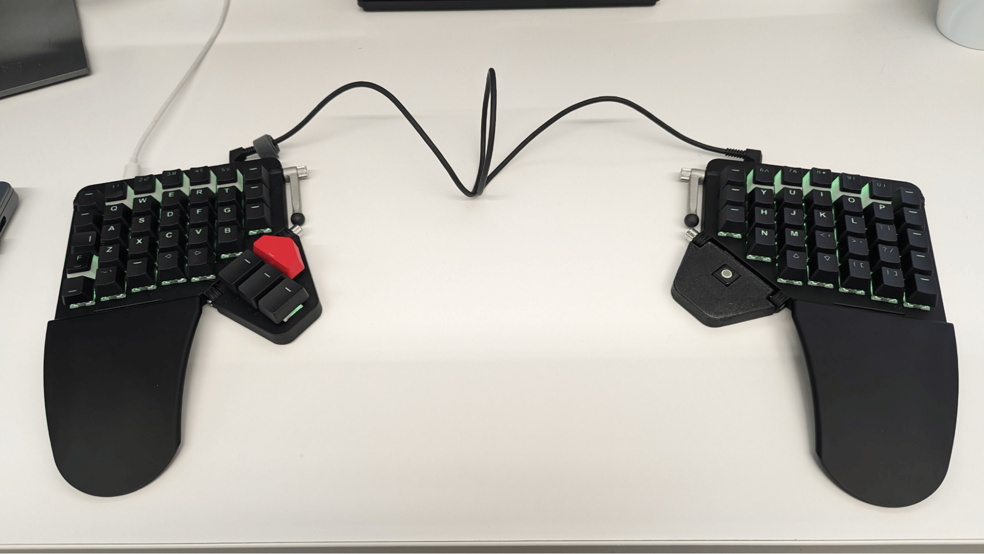 A moonlander keyboard with the right thumb cluster replaced by a tiny trackball.