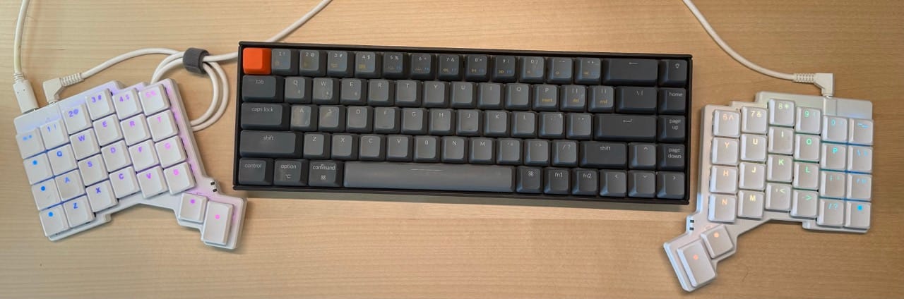 A typical keyboard with a ZSA Voyager around it