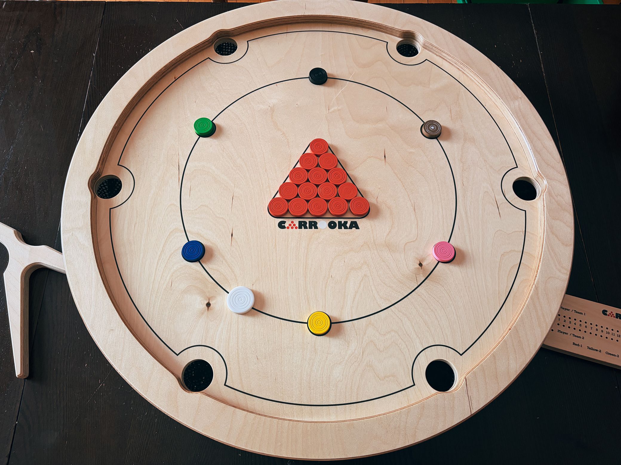 My beat up kitchen table proudly hosting a Carrooka game. I put a bit of white on the brown marker to make it easier to distinguish from the red (if you're color blind). Ready to play